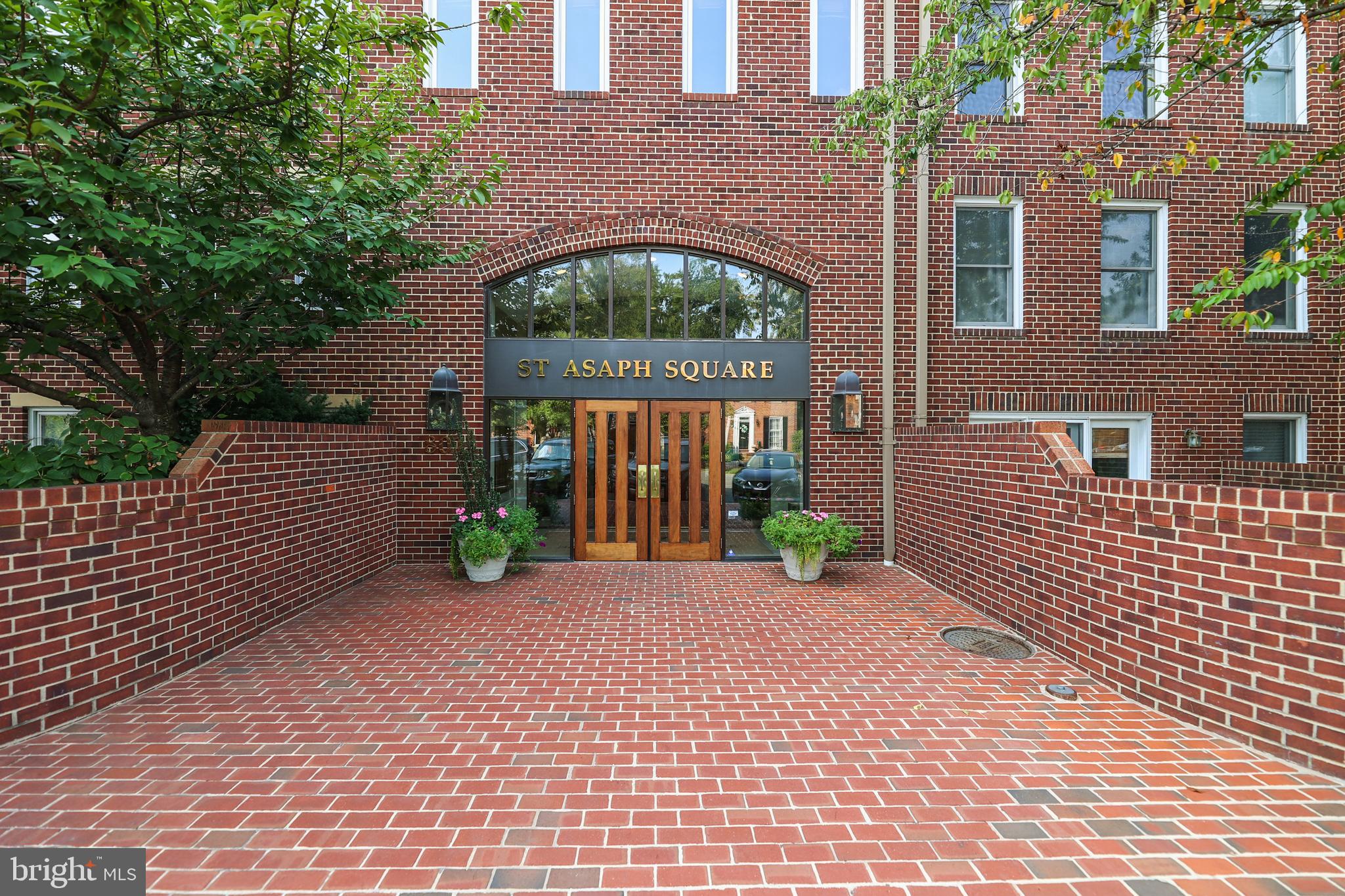 a view of a brick house with many windows