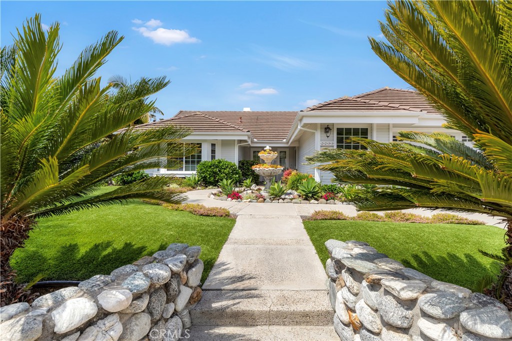 a front view of a house with a garden