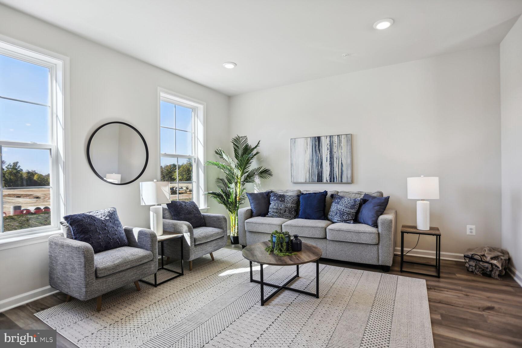 a living room with furniture a mirror and a lamp