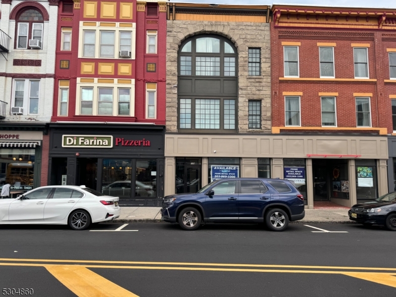 a view of a cars park in front of a building