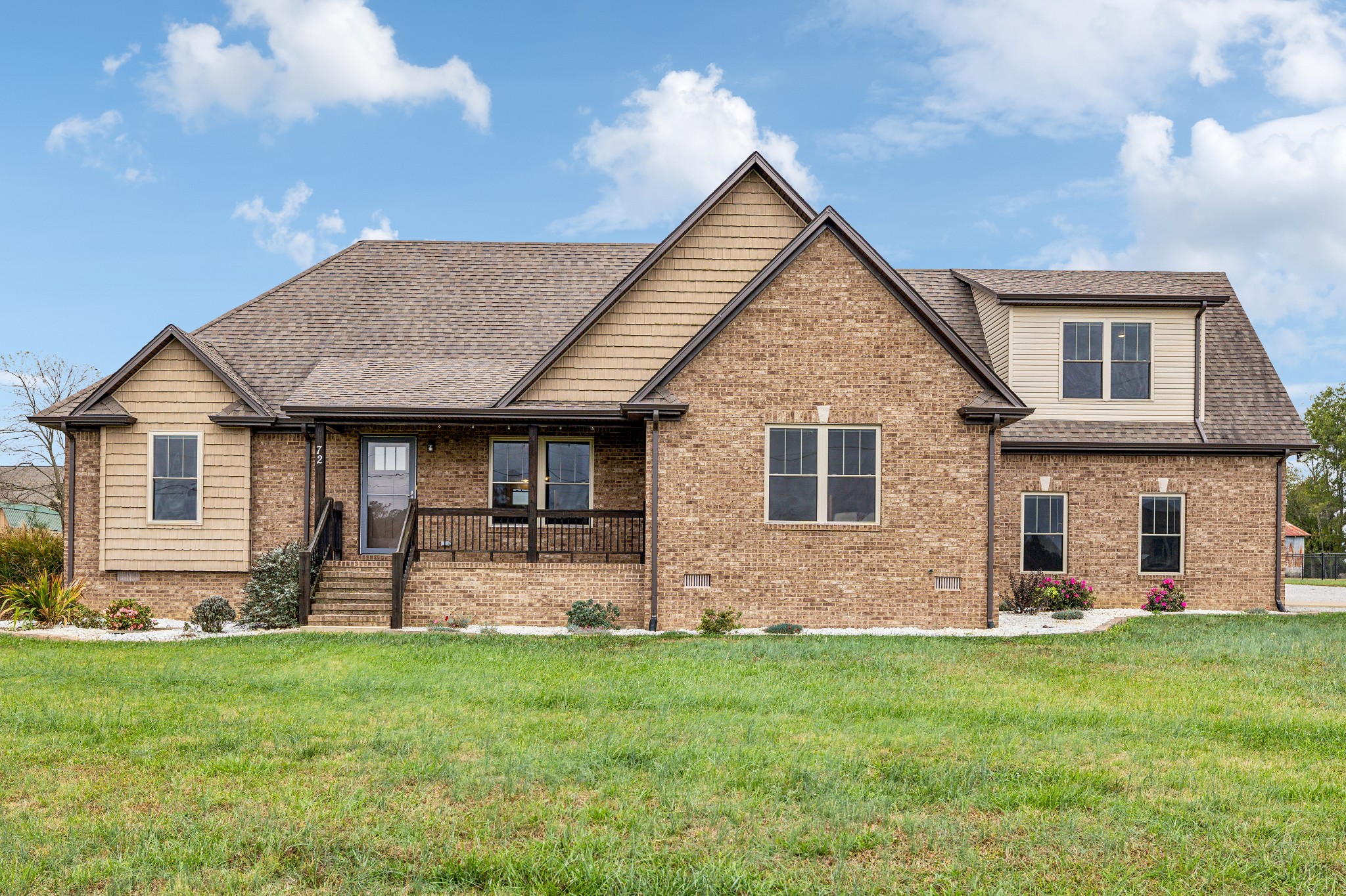 a front view of house with yard and outdoor seating