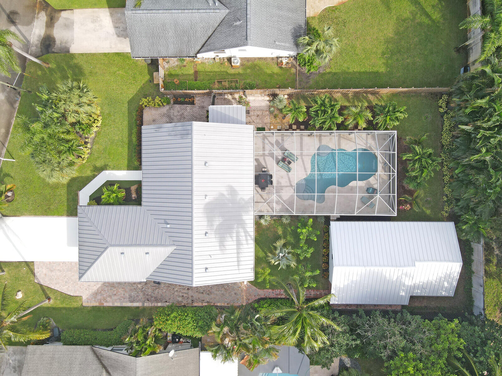 an aerial view of a house with a yard and garden