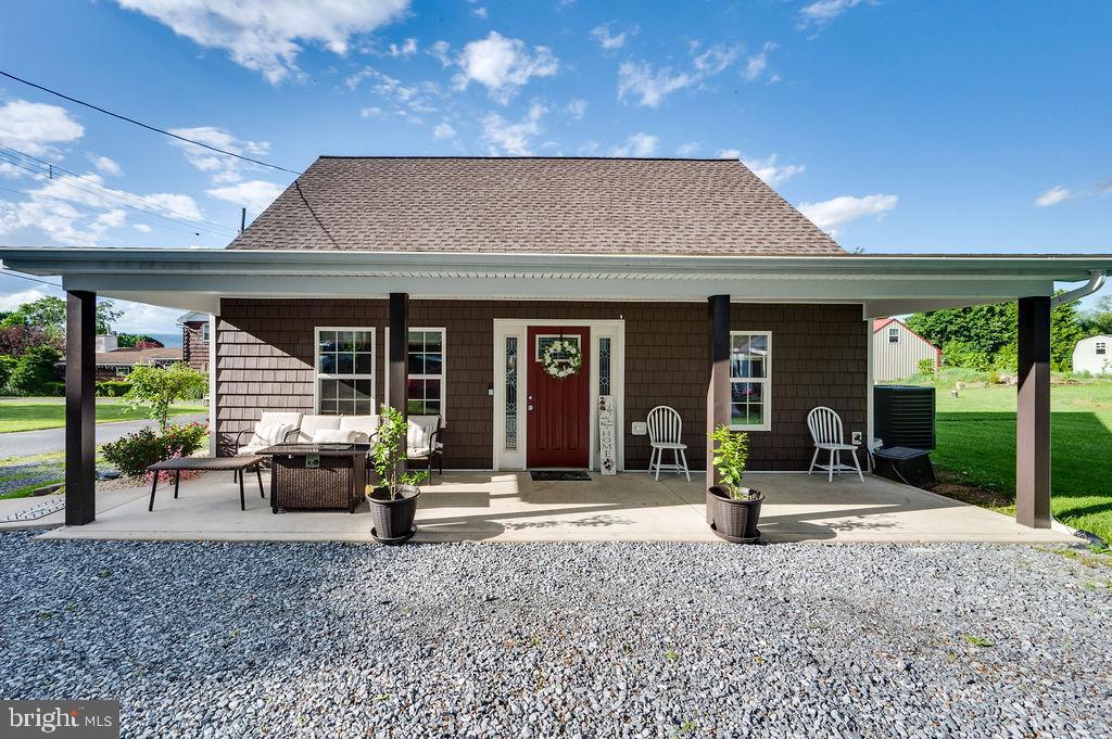 a front view of a house with porch garden and porch