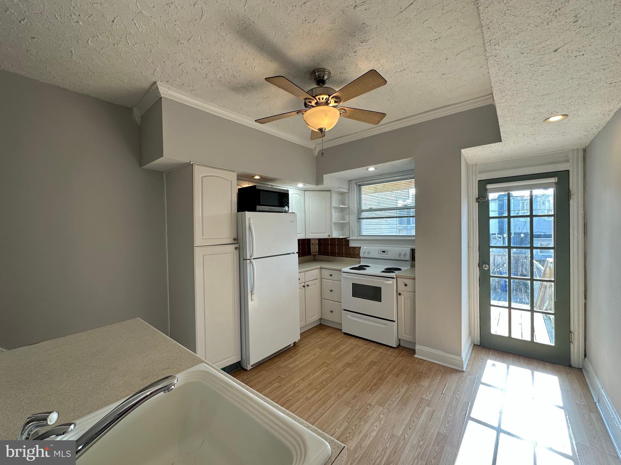 a kitchen with a refrigerator a stove top oven a sink and dishwasher