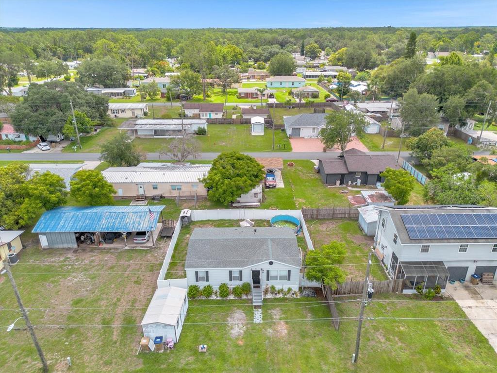 an aerial view of residential houses with outdoor space and swimming pool