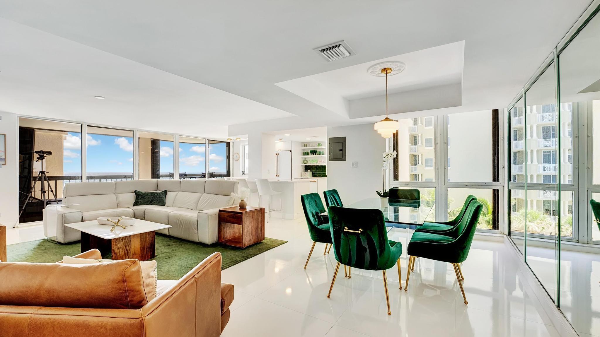 a living room with furniture and a chandelier