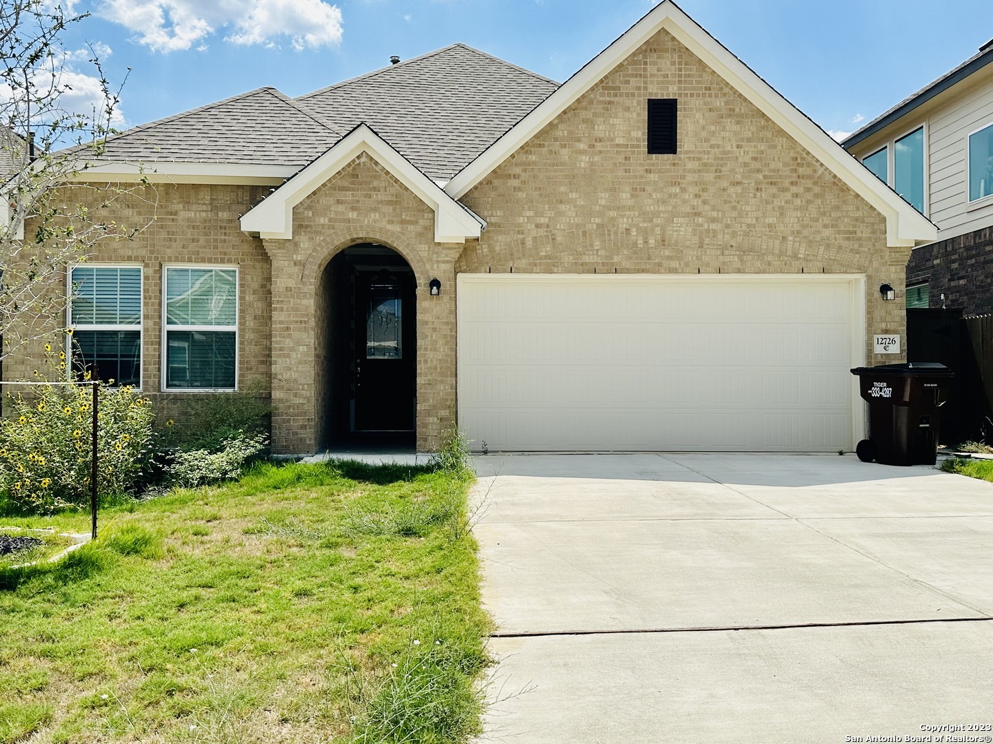 a front view of a house with a yard