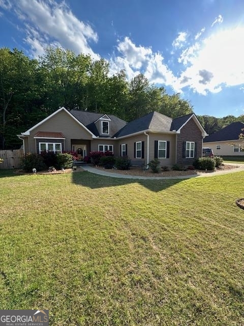 a view of a house with a big yard and large trees