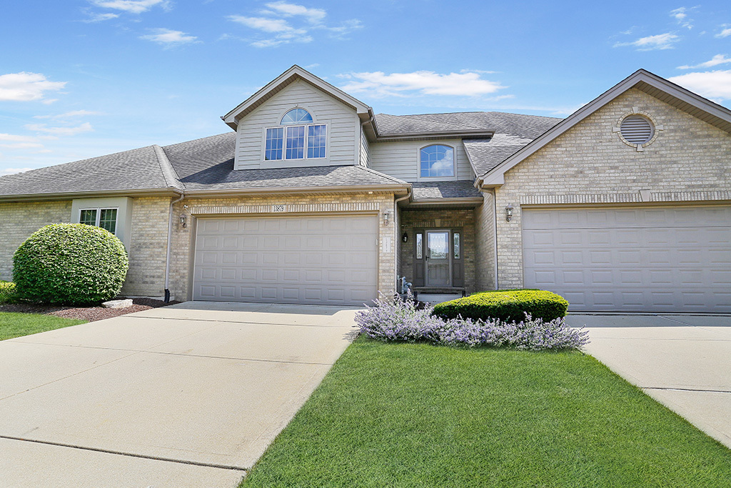 a front view of a house with a yard and garage