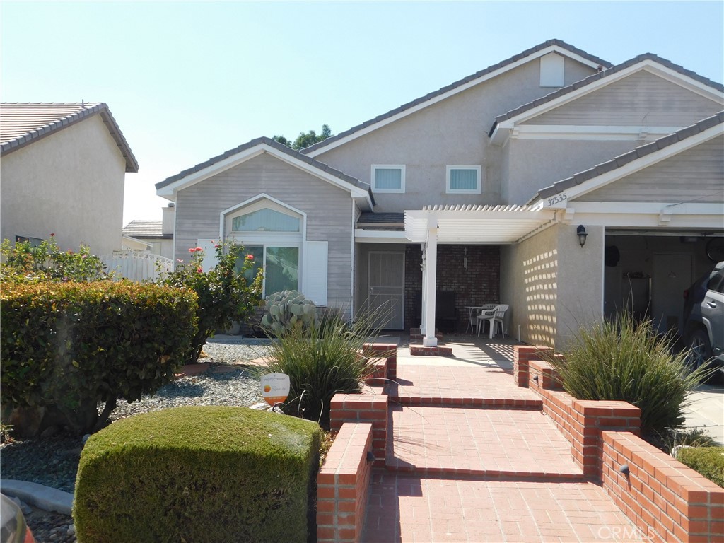 a front view of a house with garden