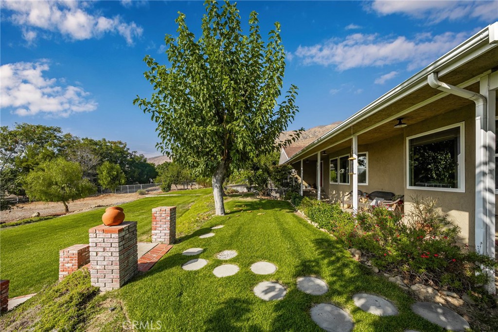 a view of a house with a backyard porch and sitting area