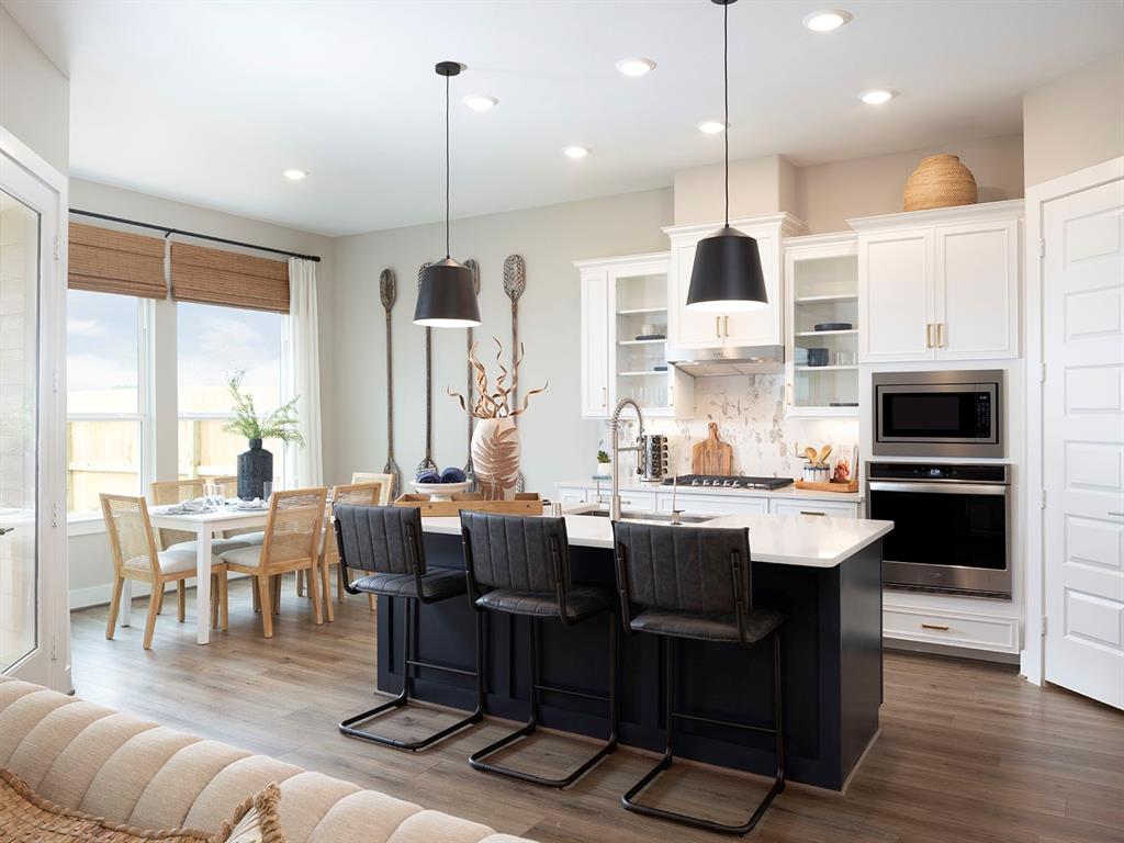 a large kitchen with a table and chairs