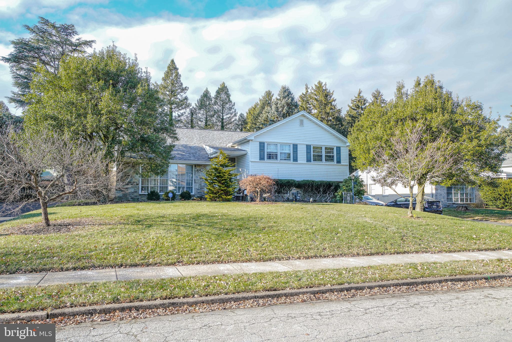 a front view of a house with a yard and a garage