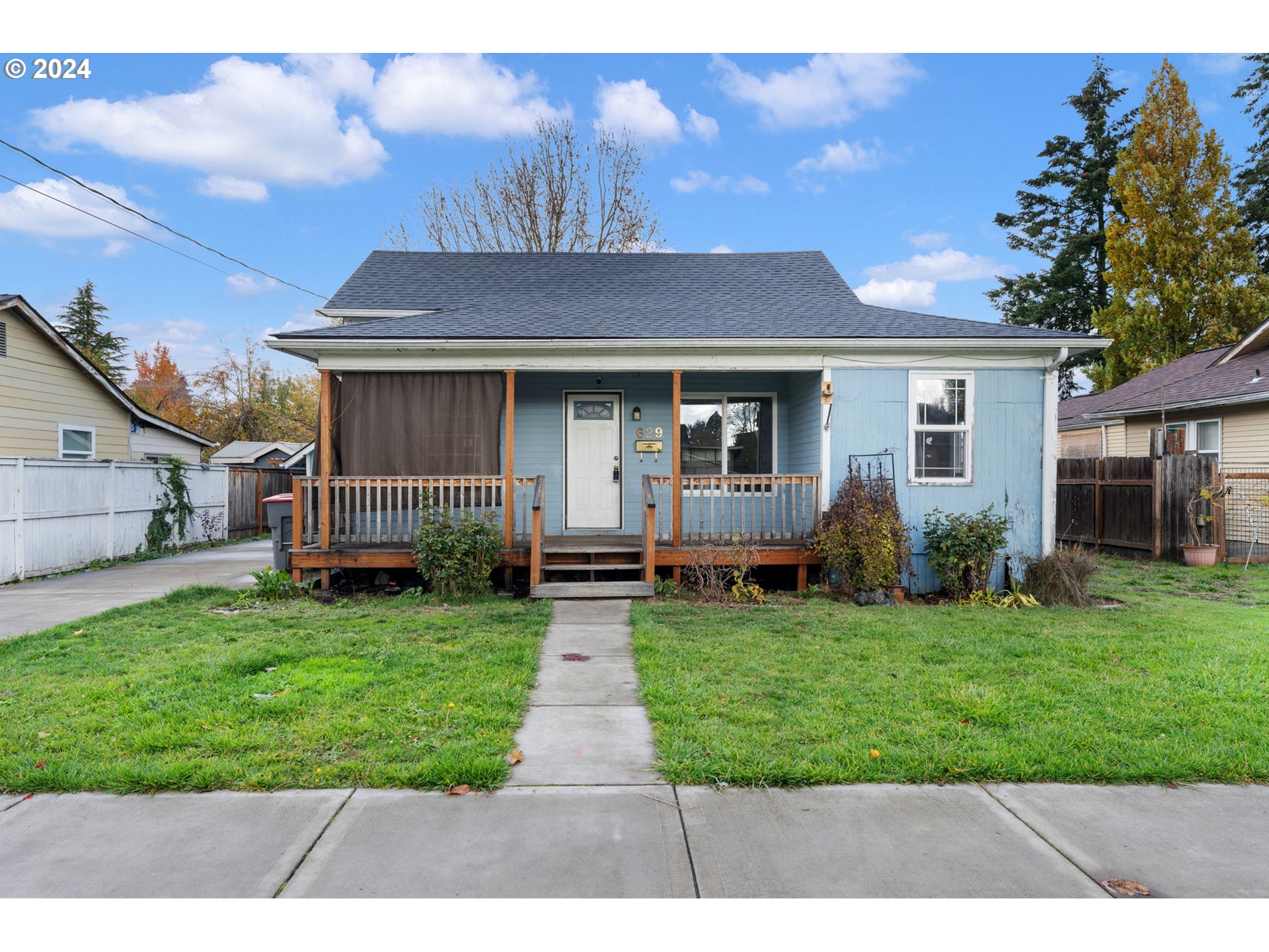 a front view of house with yard and green space