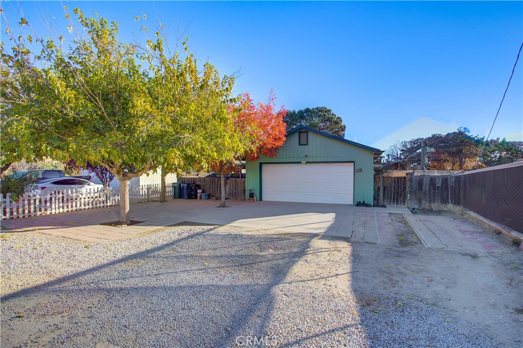 a view of a house with a yard and garage