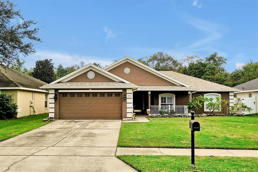 a front view of house with yard and green space