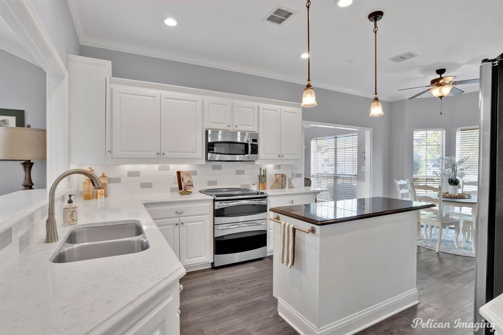 a kitchen with a sink stove and cabinets