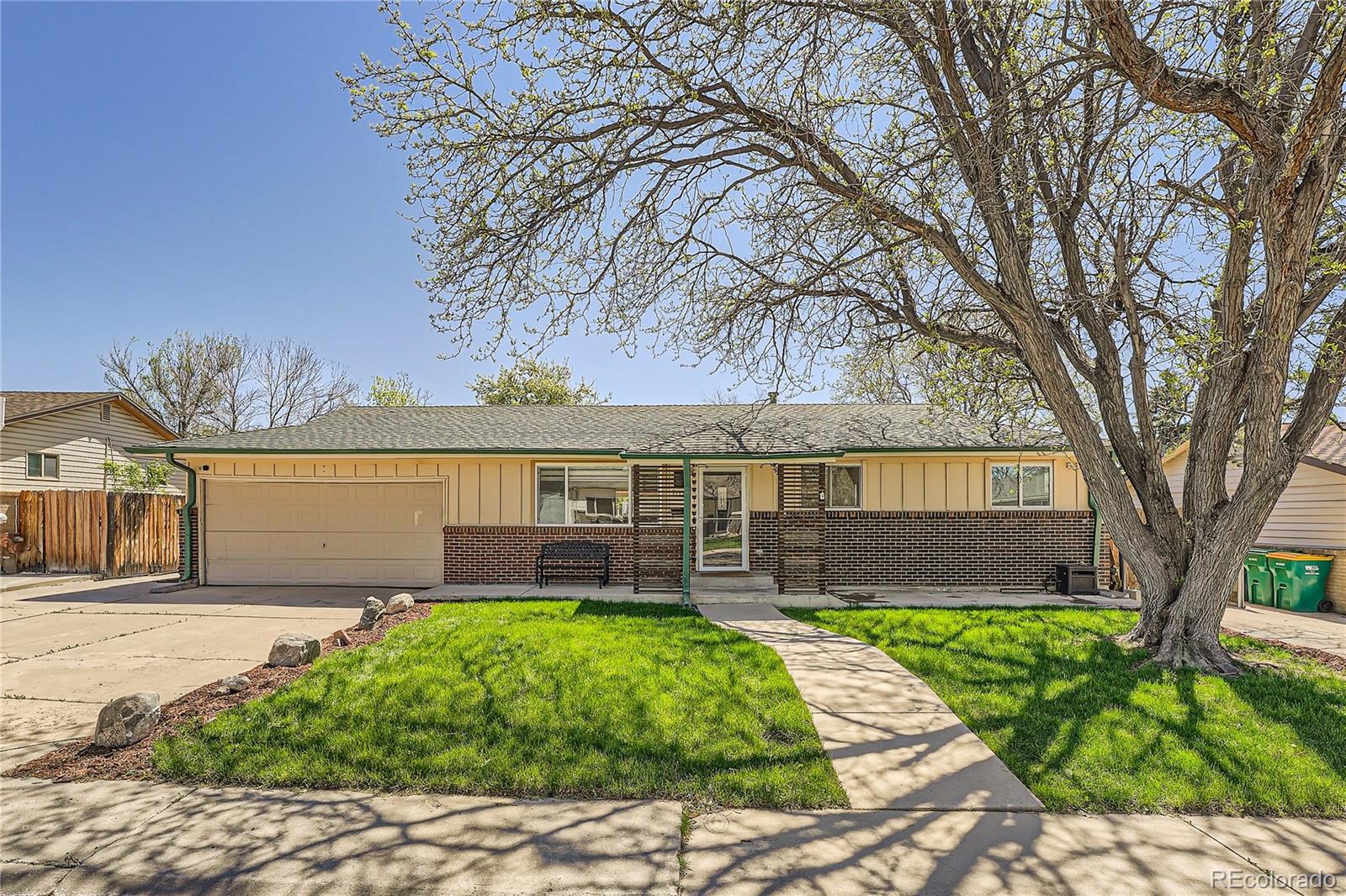 a front view of house with yard and green space