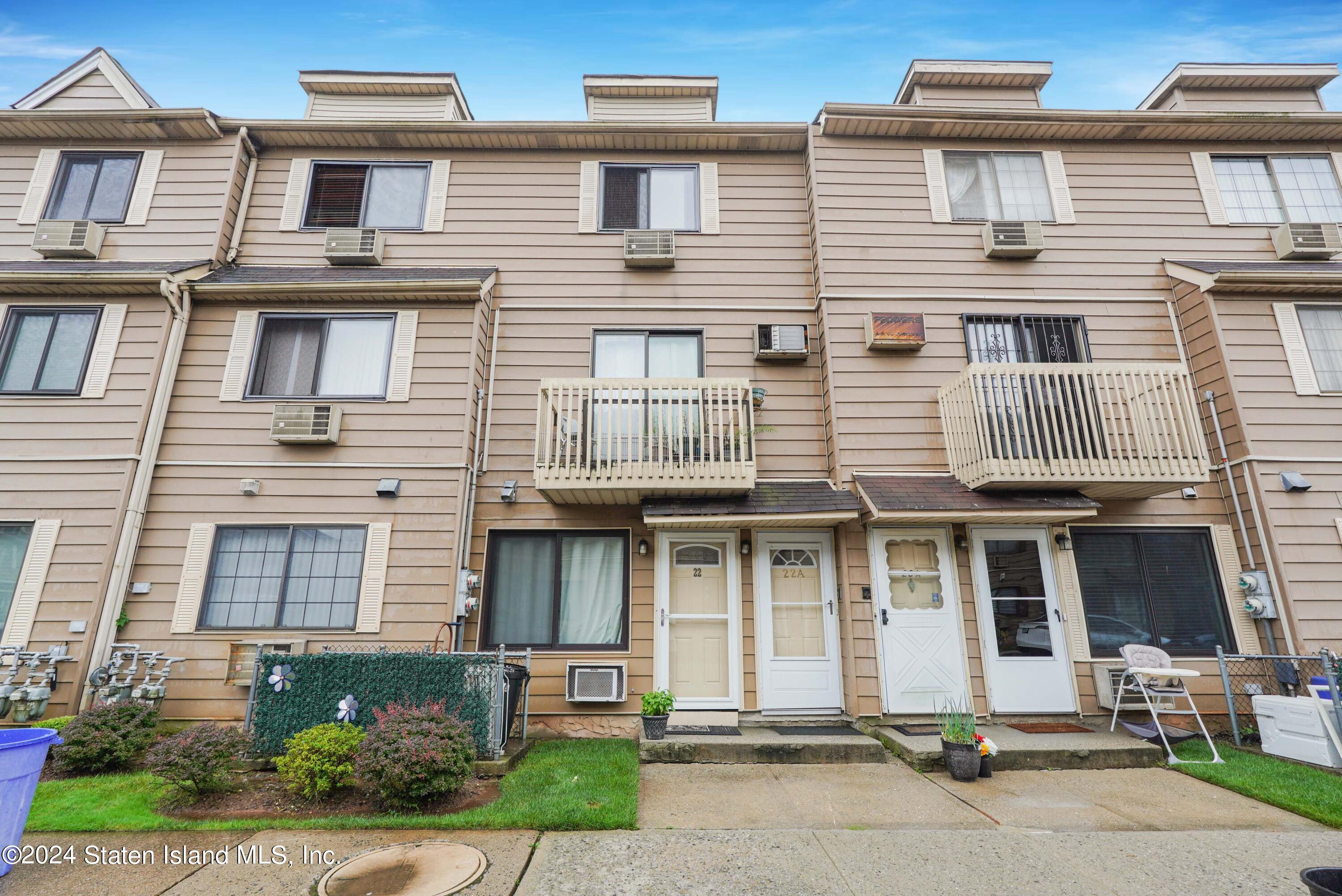 a front view of a residential apartment building with a yard