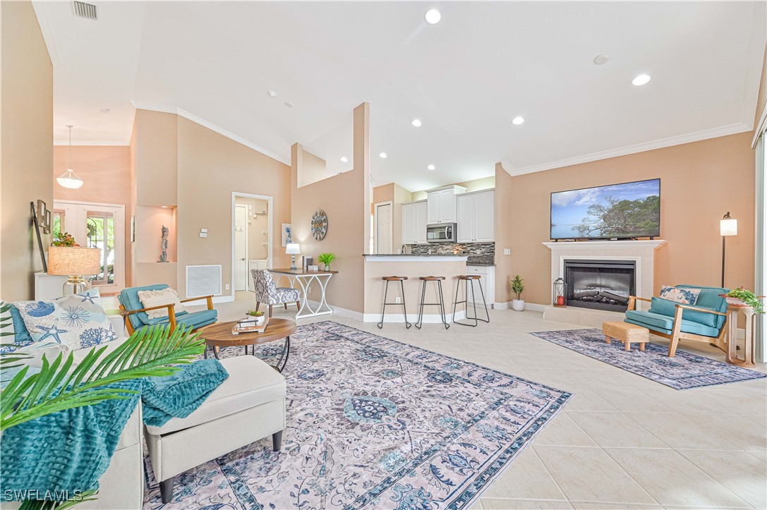 a living room with furniture a fireplace and a table