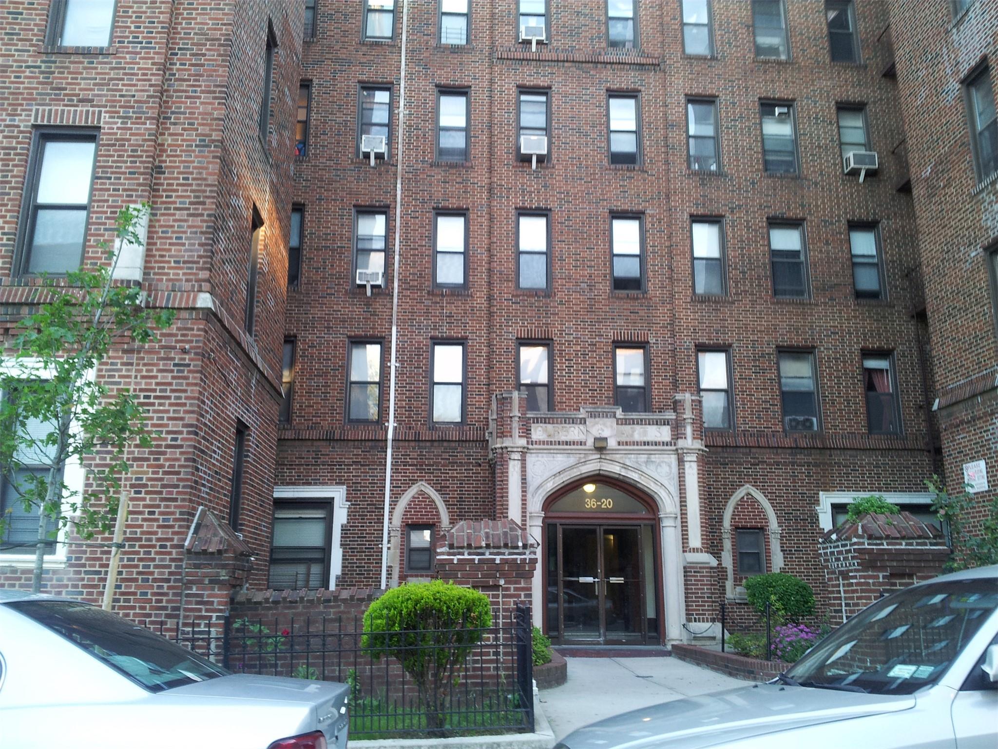 a front view of a building with plants