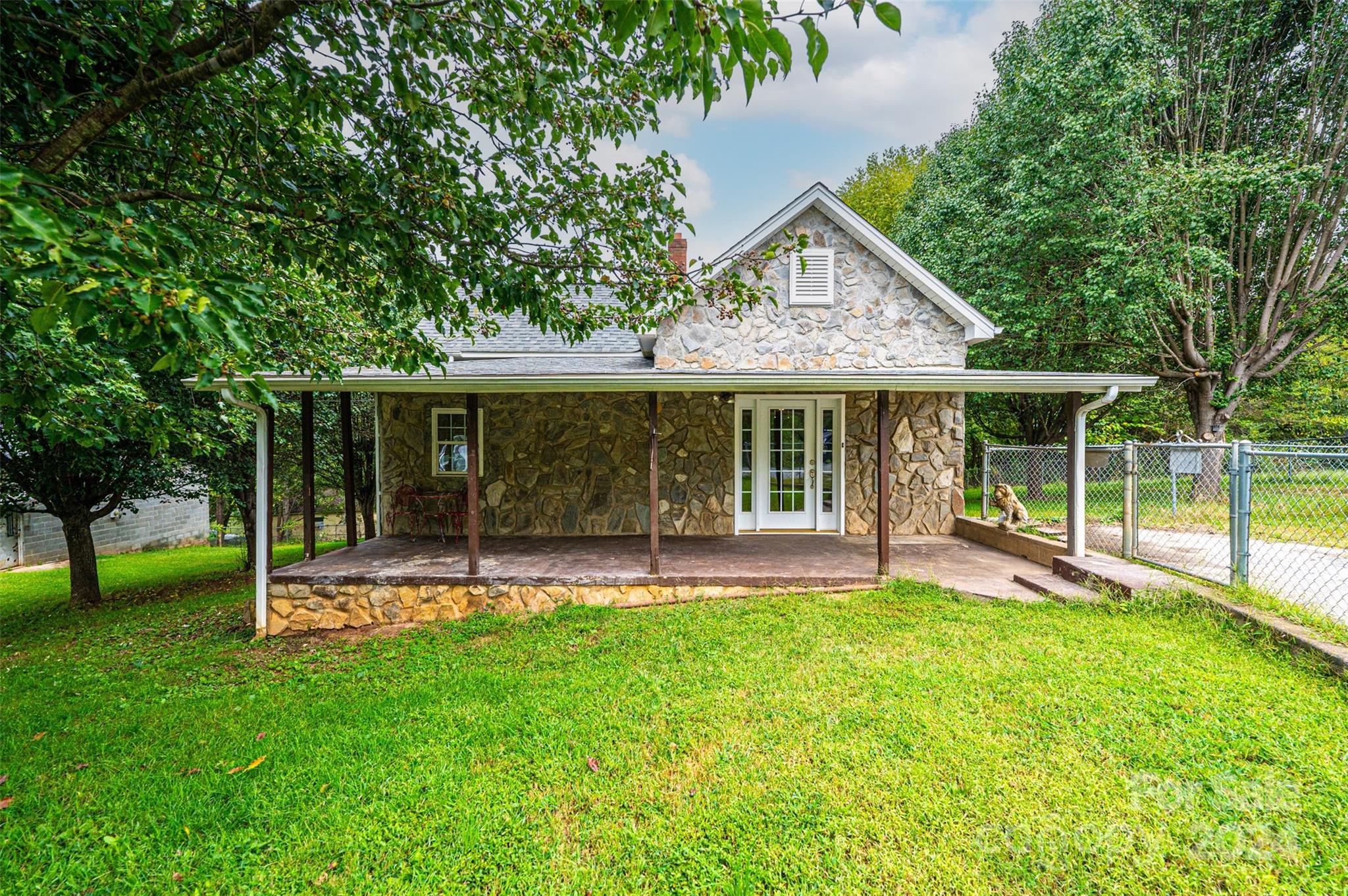 a view of a house with a yard and sitting area