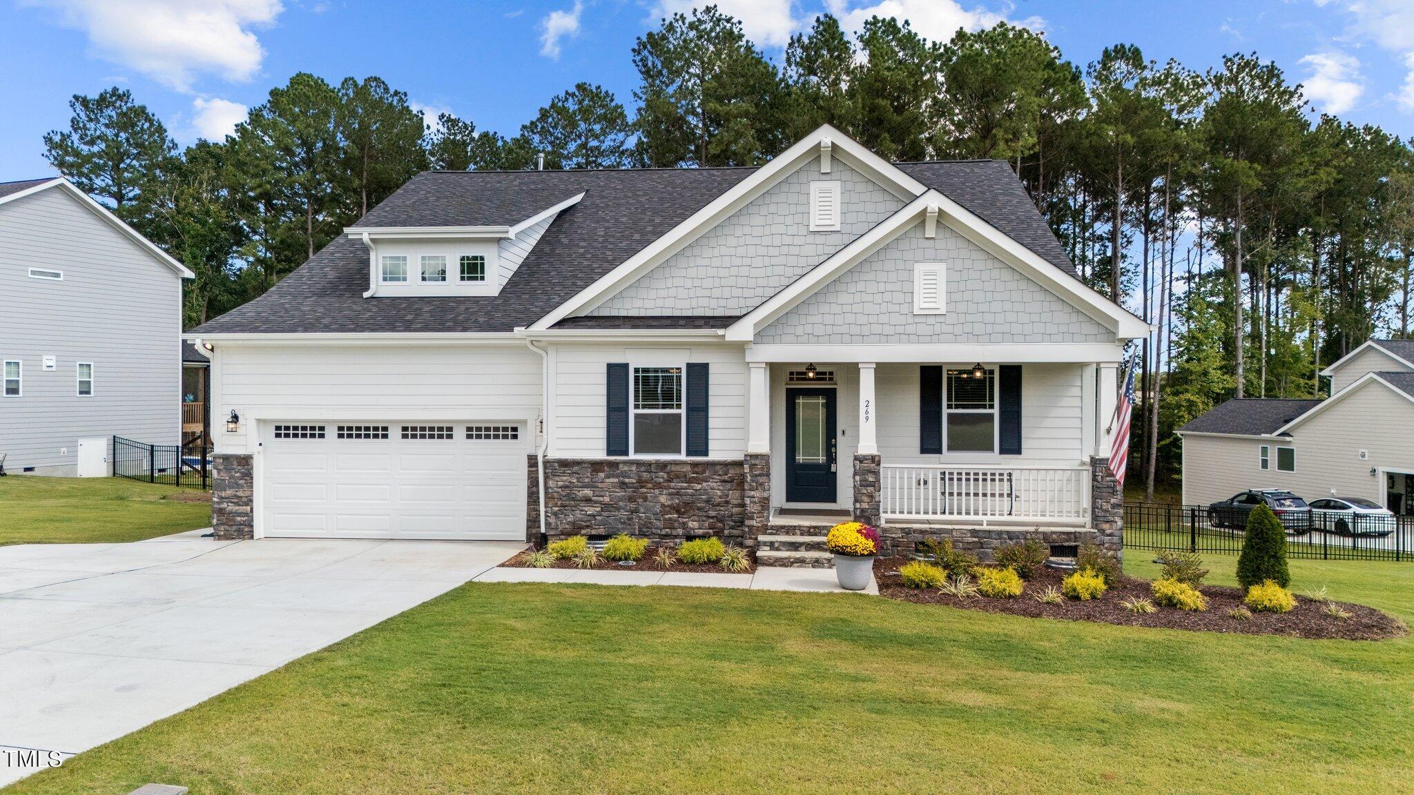 a front view of house with yard and outdoor seating