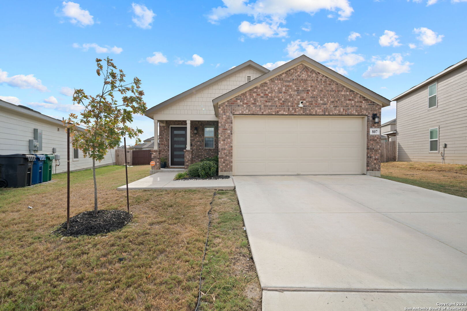 a view of a house with a yard and garage