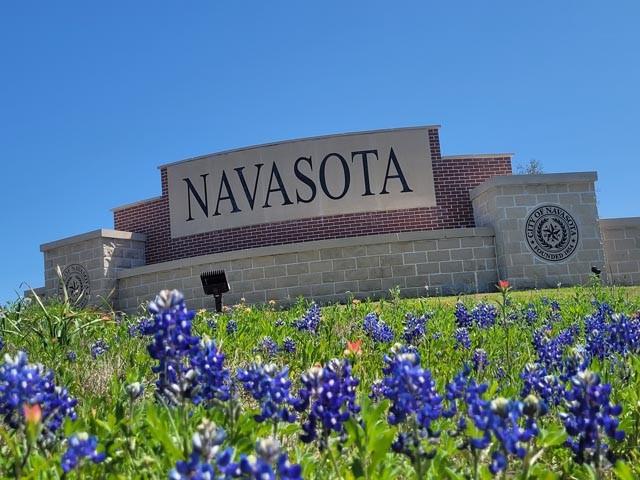 a sign that is in front of flowers