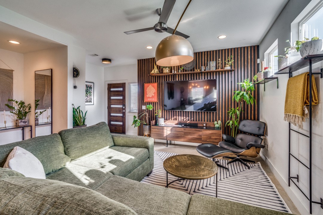 a living room with furniture a rug and a chandelier