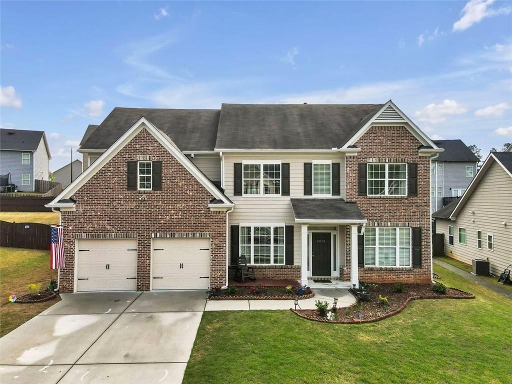 a front view of a house with a yard fire pit and outdoor seating