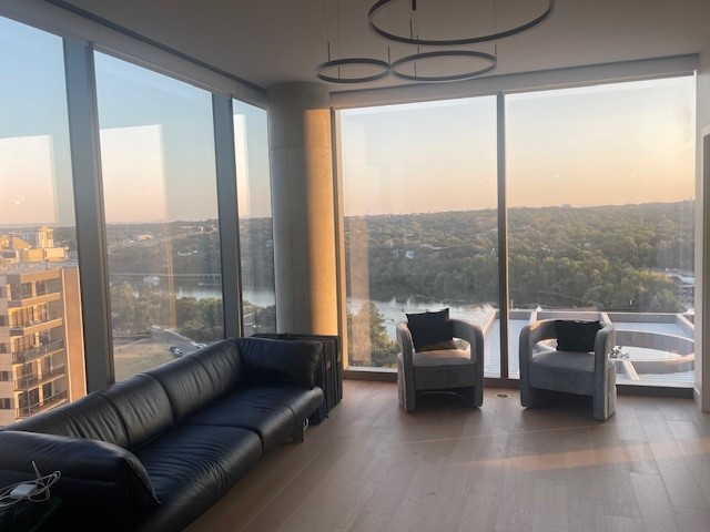 a living room with furniture and a floor to ceiling window