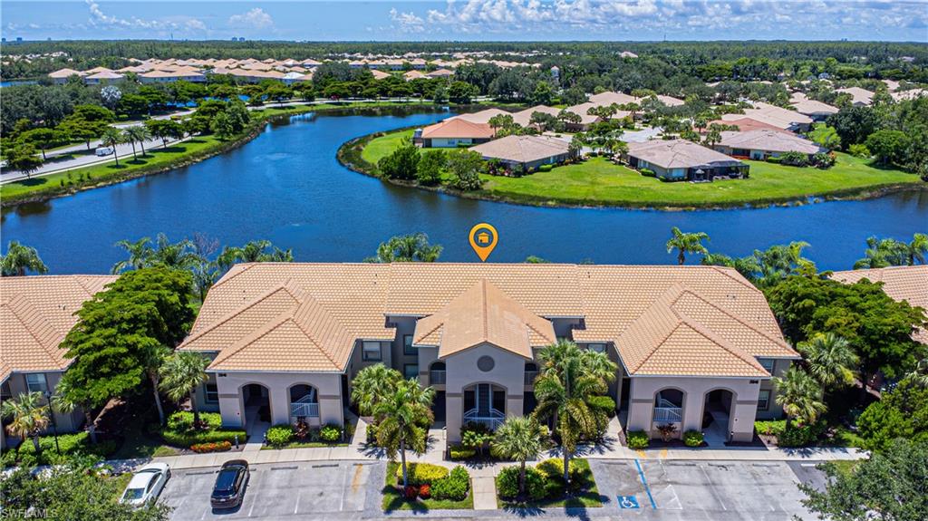 an aerial view of house with yard swimming pool and ocean view