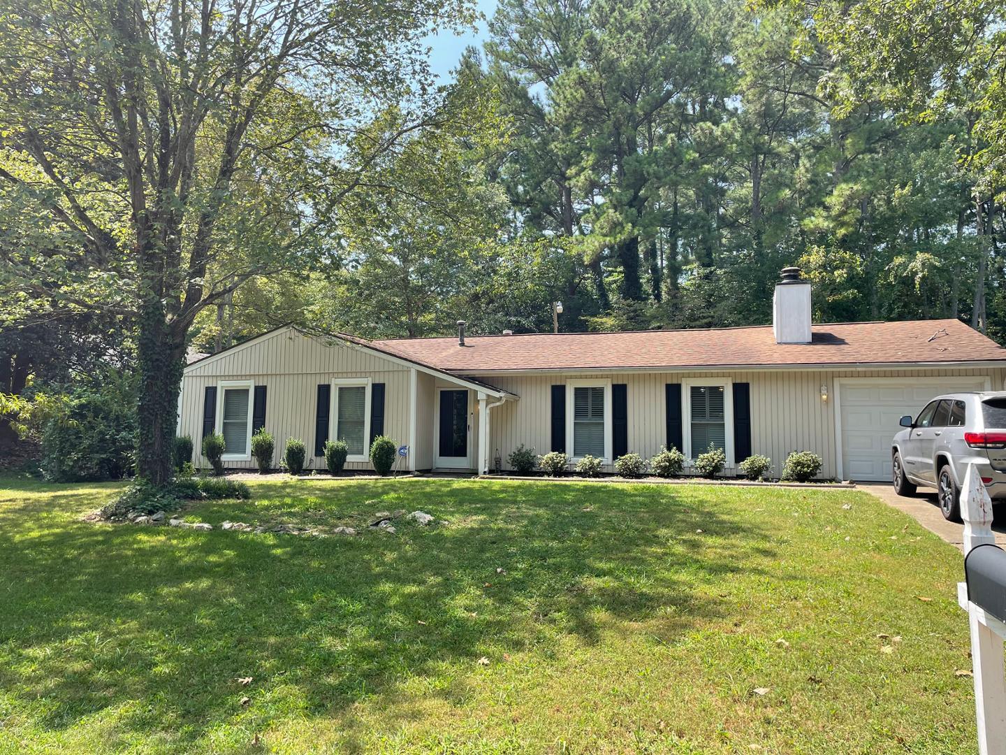 a front view of a house with a garden