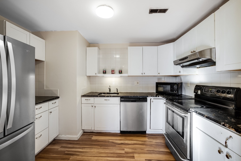 a kitchen with stainless steel appliances a sink stove and refrigerator