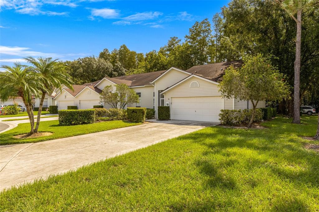 a view of a house with a yard and tree s