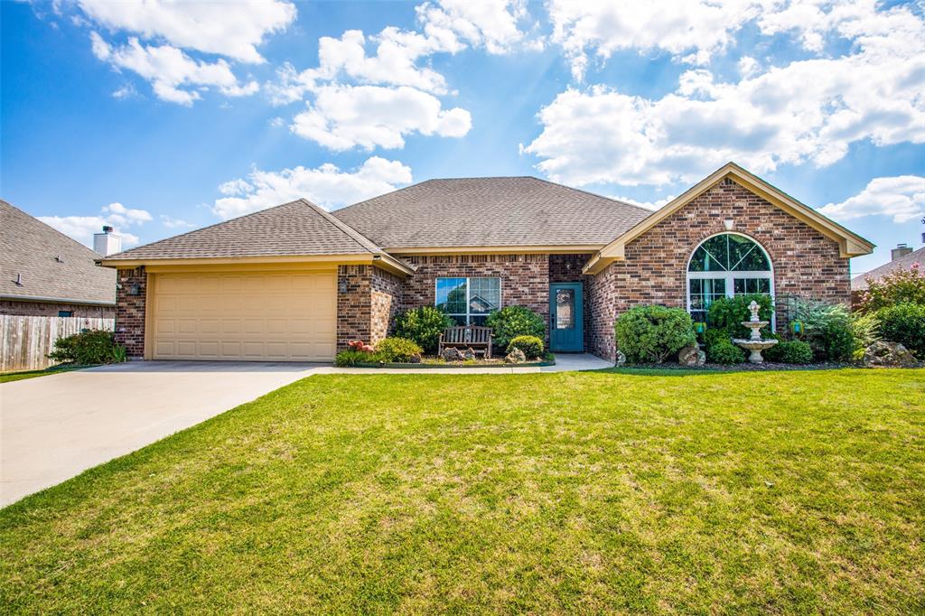 a front view of house with yard and patio