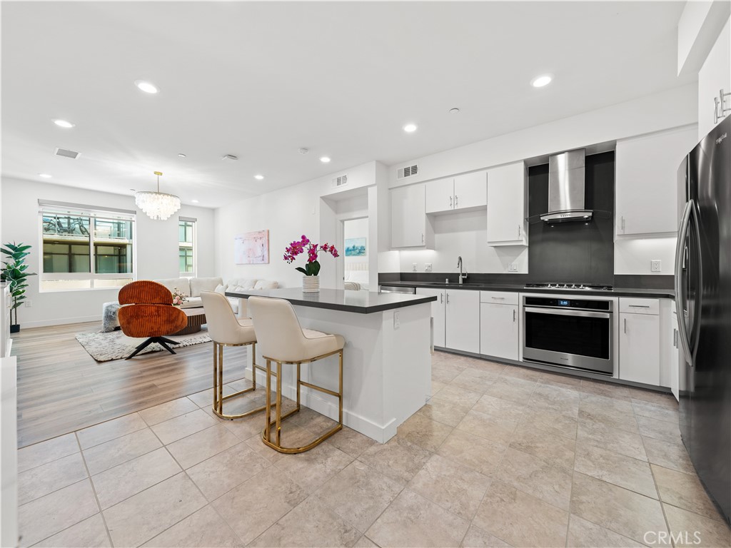 a kitchen with stainless steel appliances granite countertop a sink and cabinets