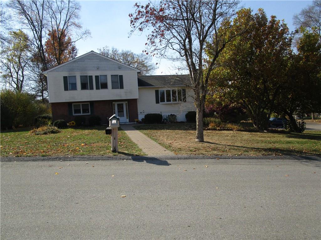 Split level home with a front lawn