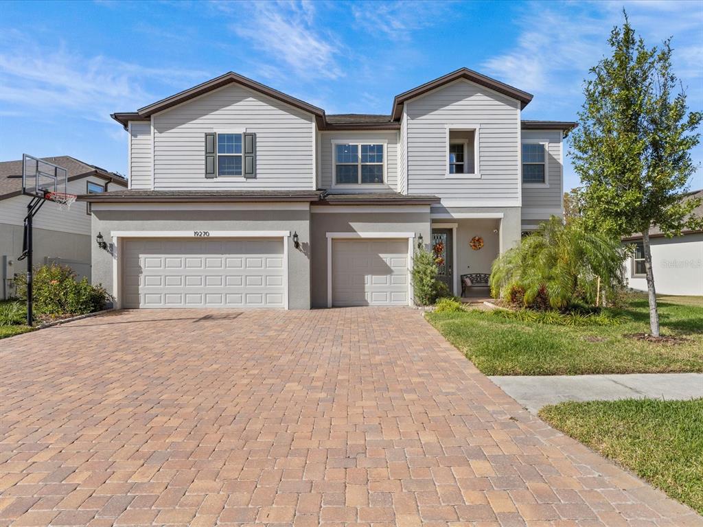 a front view of a house with a yard and garage