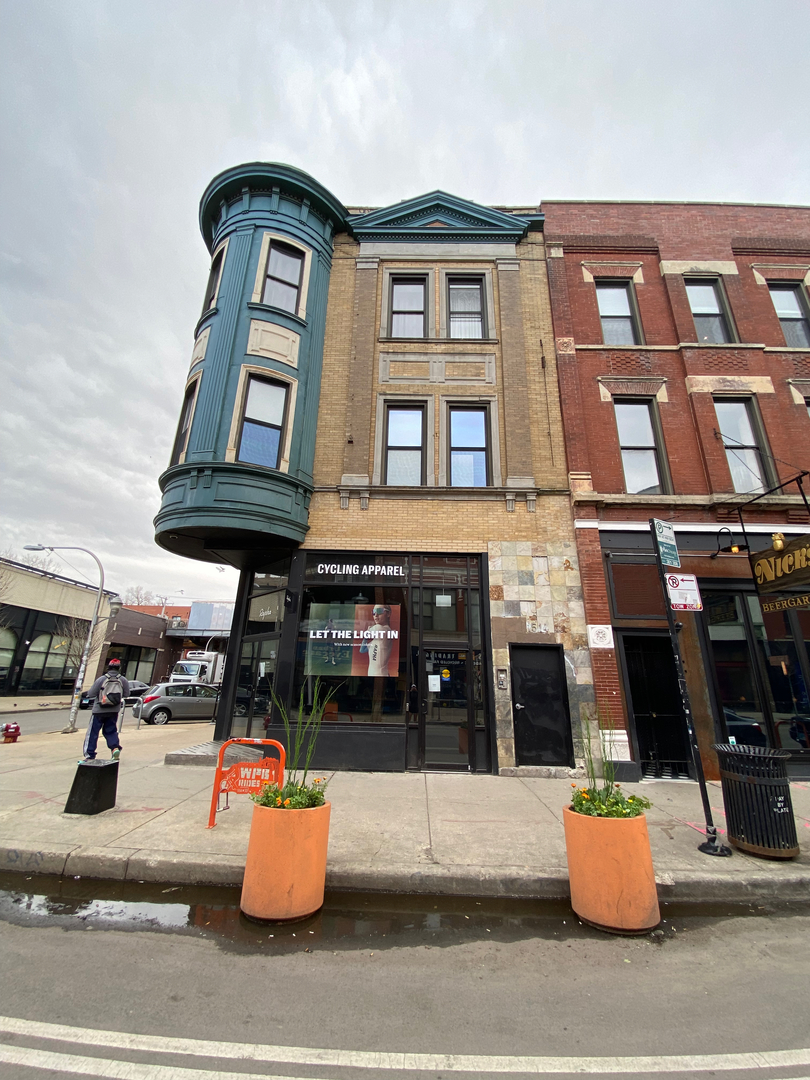 a front view of a building with outdoor seating