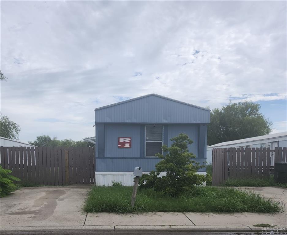 a house with green field in front of it