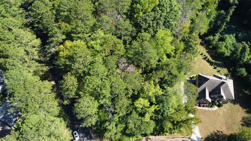 an aerial view of a house with yard