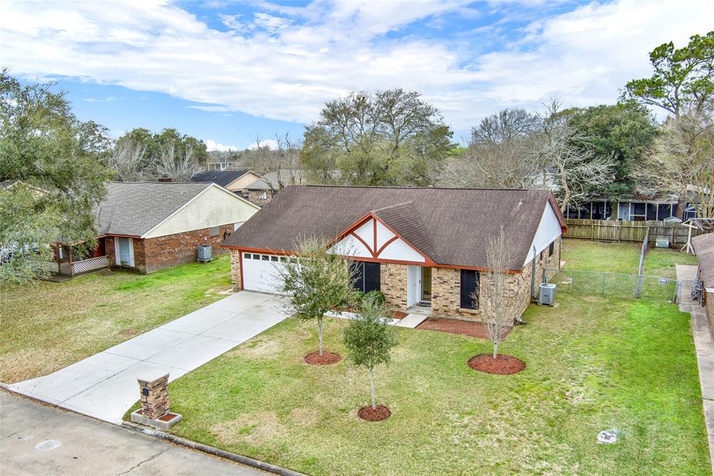 an aerial view of a house with yard patio and green space