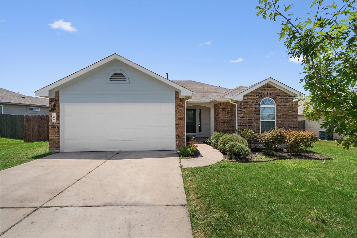 Welcome to 109 Jim Dandy Dr! Eye-catching curb appeal with its brick exterior, low maintenance lawn, and two-car garage.