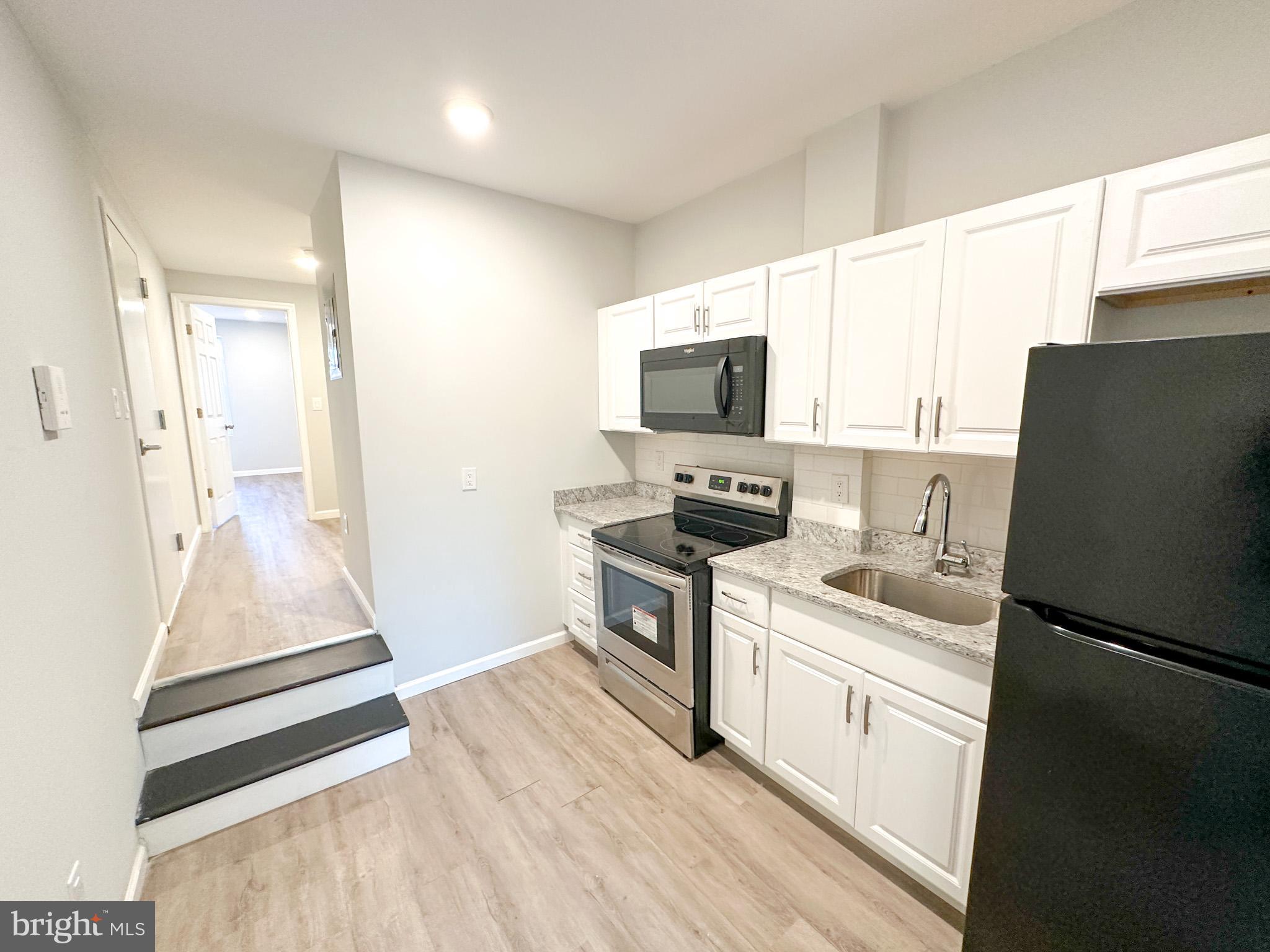 a kitchen with a refrigerator stove and sink