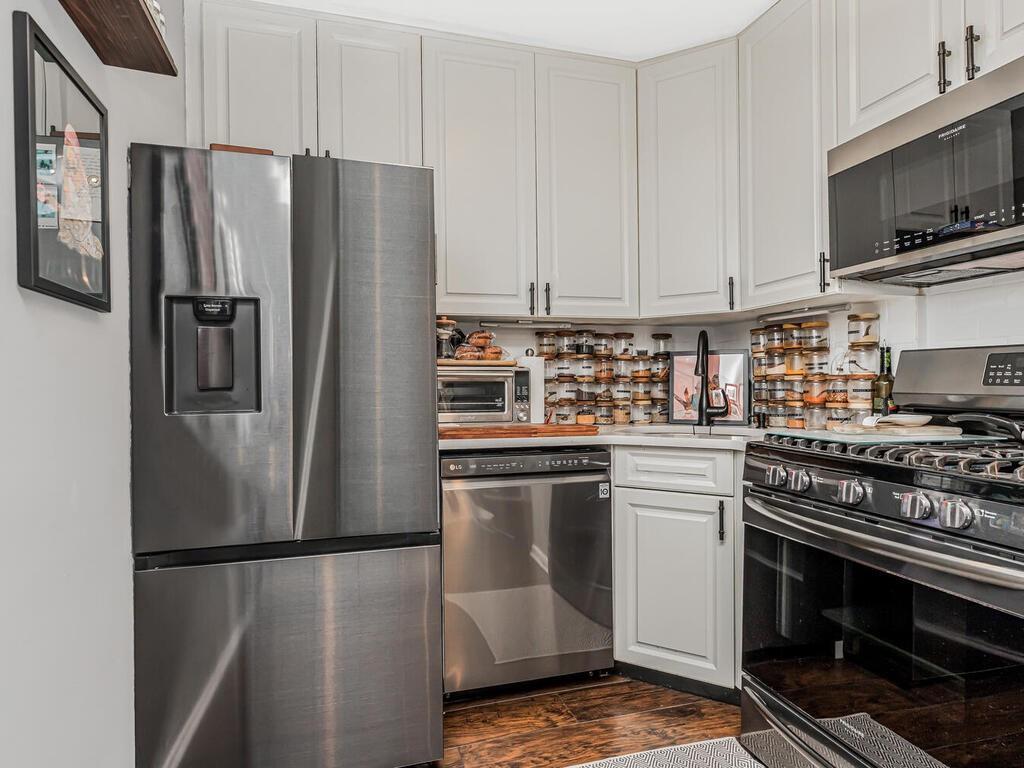 a kitchen with stainless steel appliances granite countertop a refrigerator stove and microwave