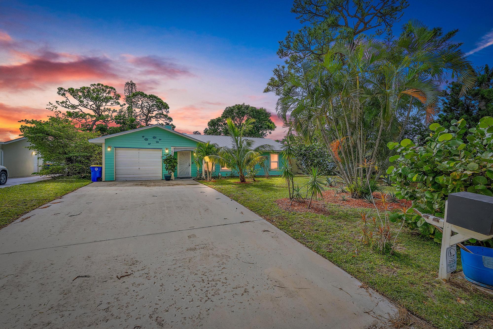 a front view of a house with a yard and a garage