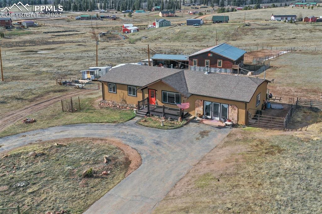 an aerial view of a house with a yard patio and dining space