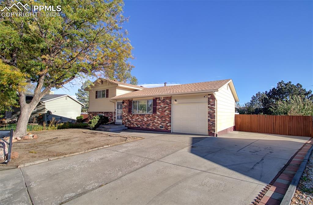 a view of a house with a yard and garage